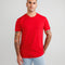 Man wearing a red t-shirt against a gray background